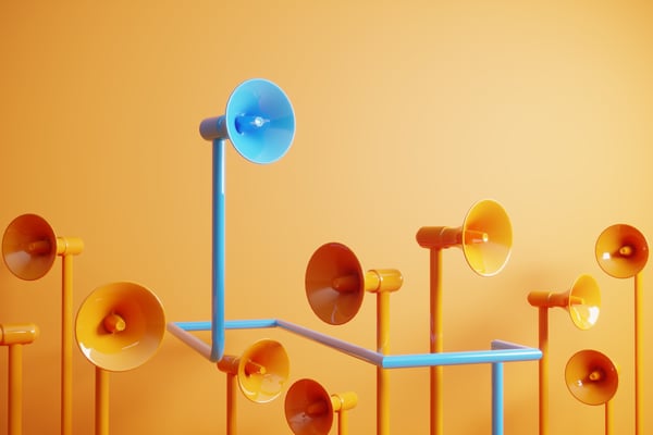 Blue megaphone stands out from the crowd of orange megaphones